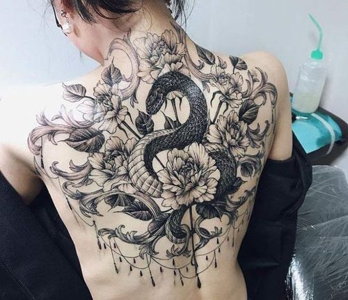 Spine tattoo  back tattoo of snake wrapped around flowers Done by Mando  Castro at Sacred Seas Tattoo Utah  rtattoo