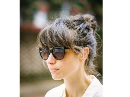 Bun_with_bangs_hairstyle_with_glasses_for_women_over_60