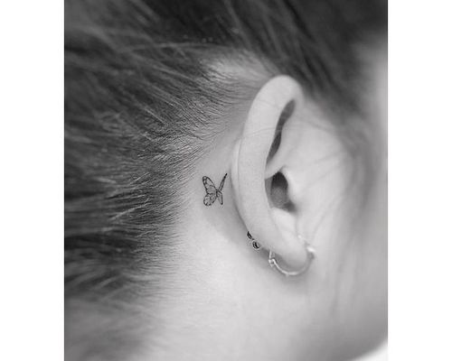Small intricate butterfly tattoo behind the ear…