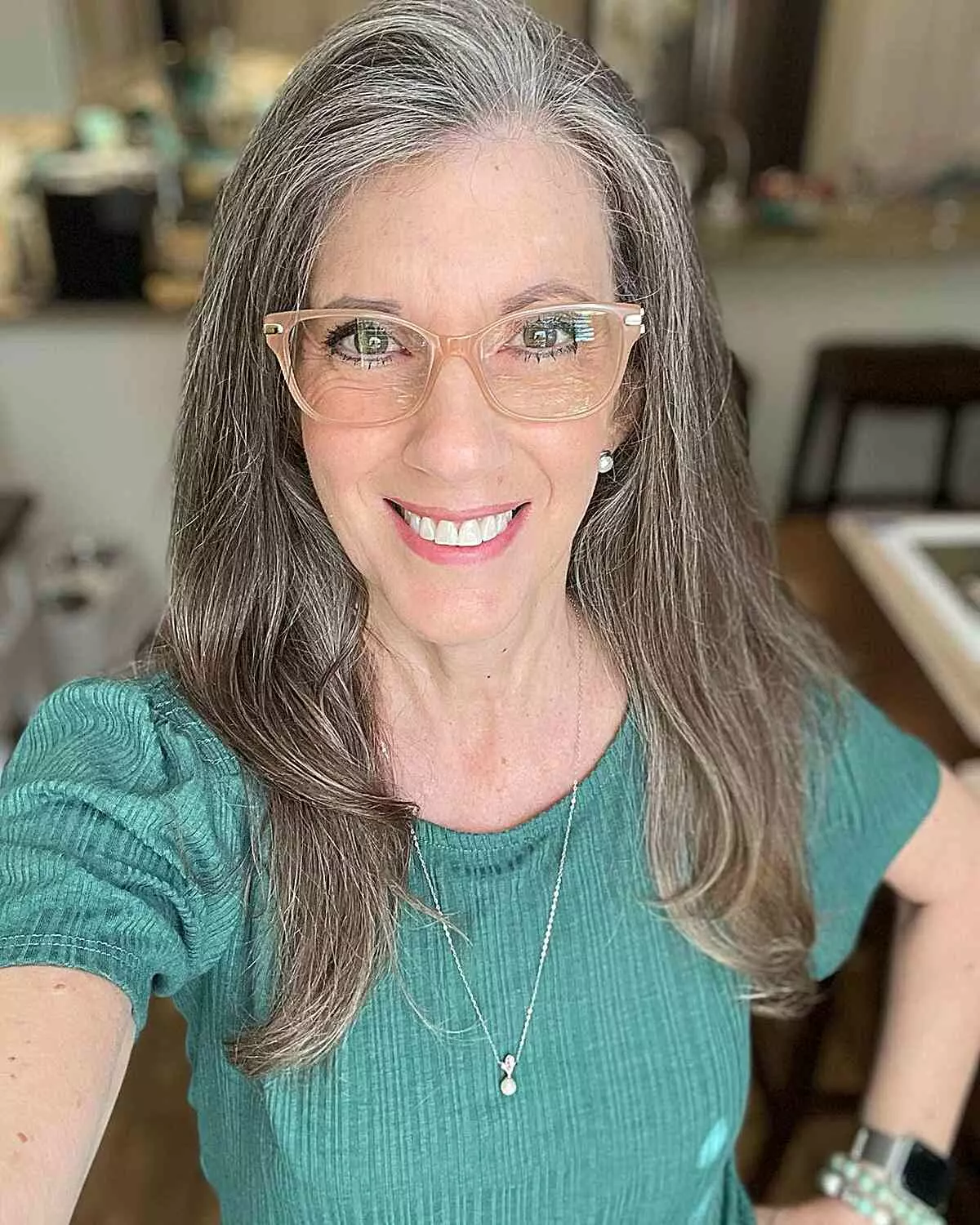 long-silver-hair-with-a-side-part-and-lots-of-layering-for-women-over-50-with-glasses