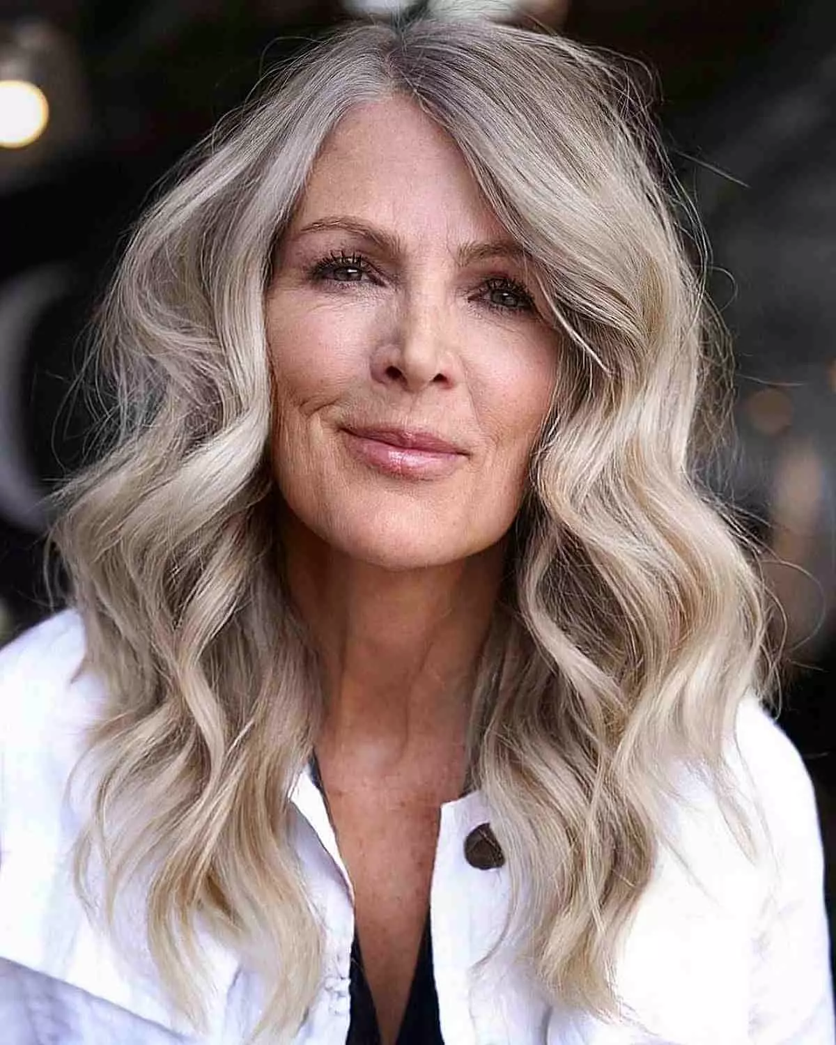mid-length-wavy-hair-with-a-side-part-for-60-year-old-ladies
