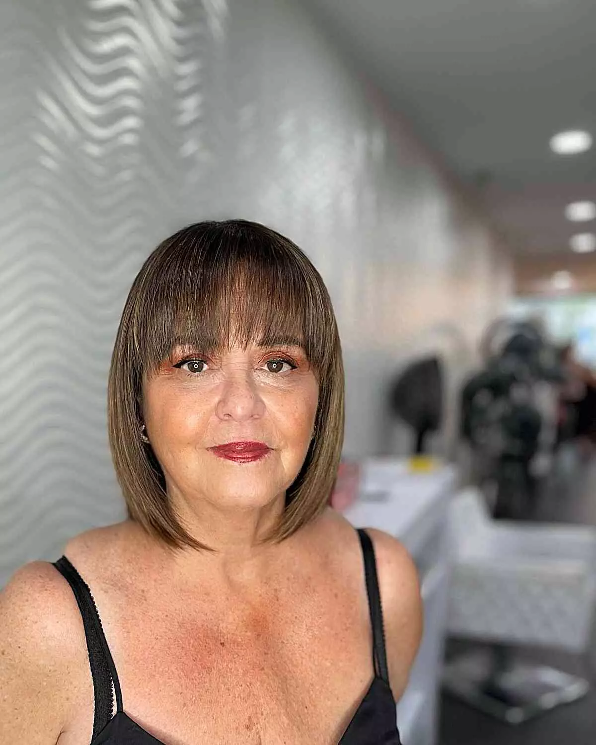 neck-grazing-brunette-bob-with-bangs-for-ladies-aged-sixty-with-fine-hair