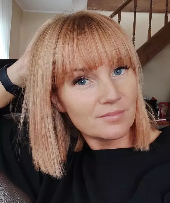 strawberry blonde hair with bangs