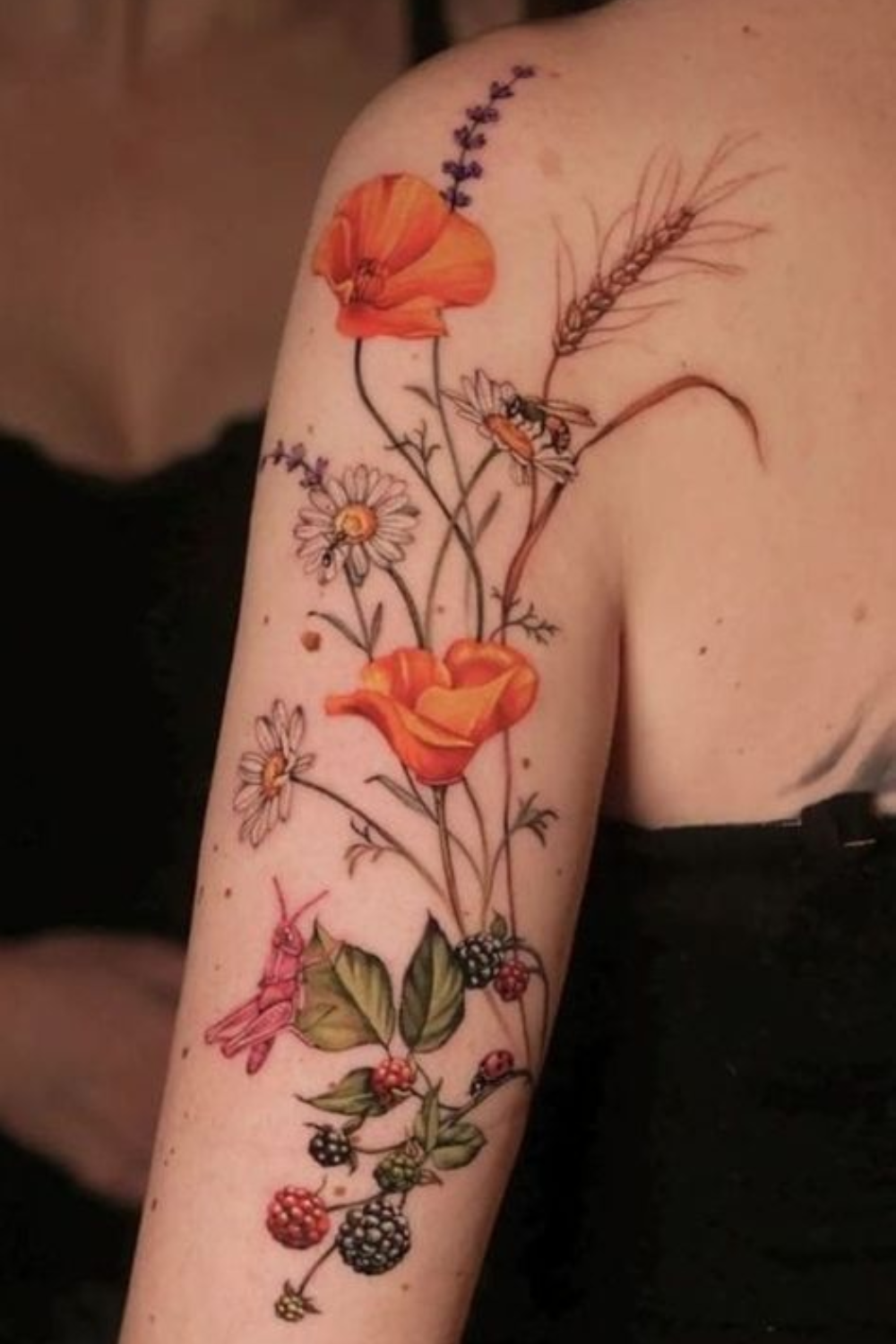 orange lavender and white flower tattoo on arm and shoulder