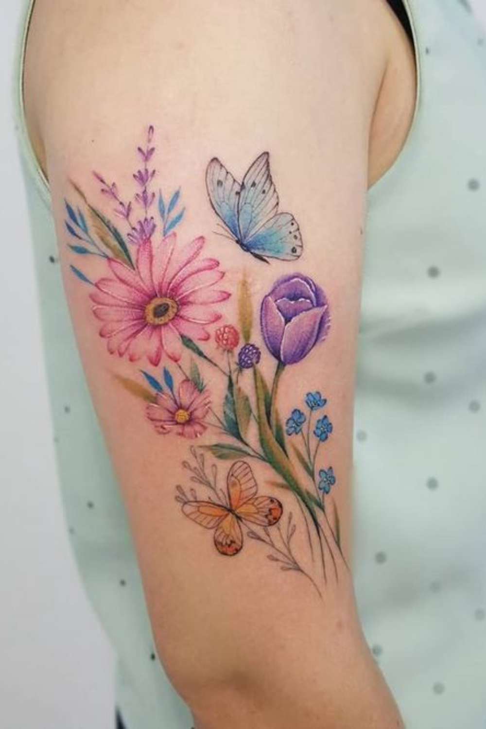 colorful flower tattoo with butterfly on arm