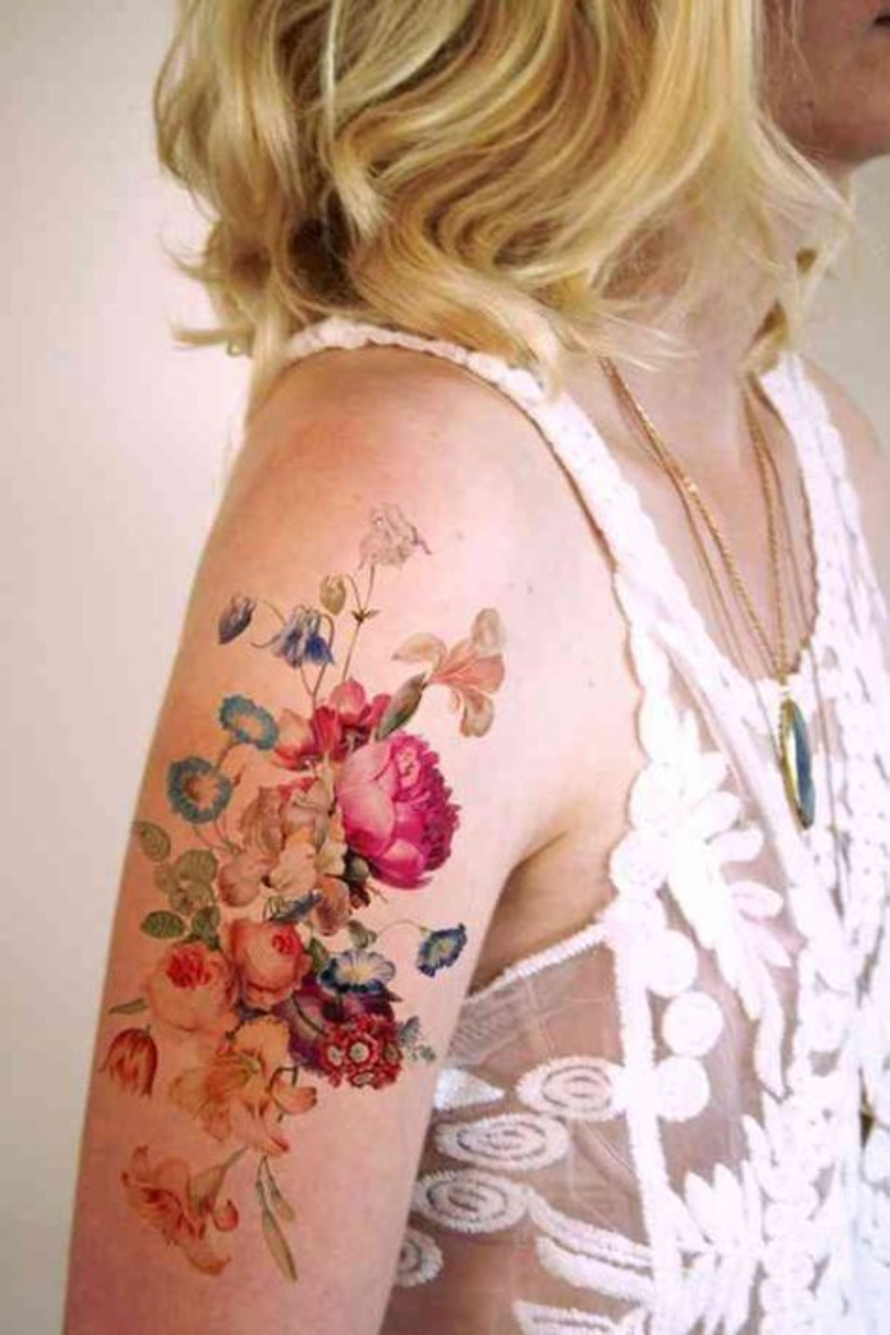 tattoo with colorful small flowers on arm