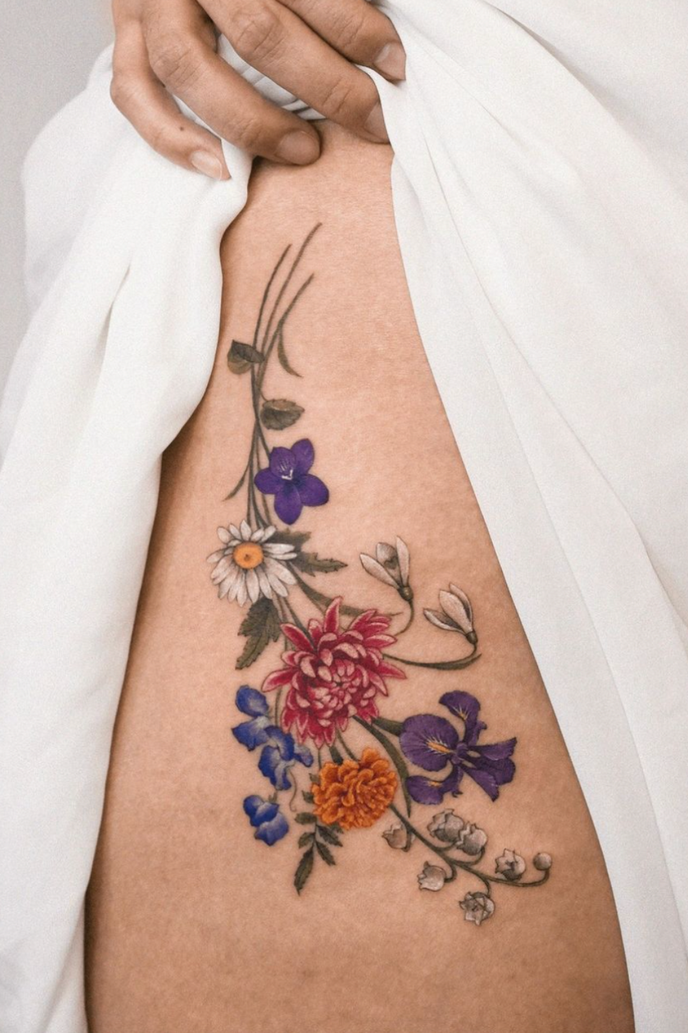 bouquet of flowers tattoo with waterlily, violet, lavender