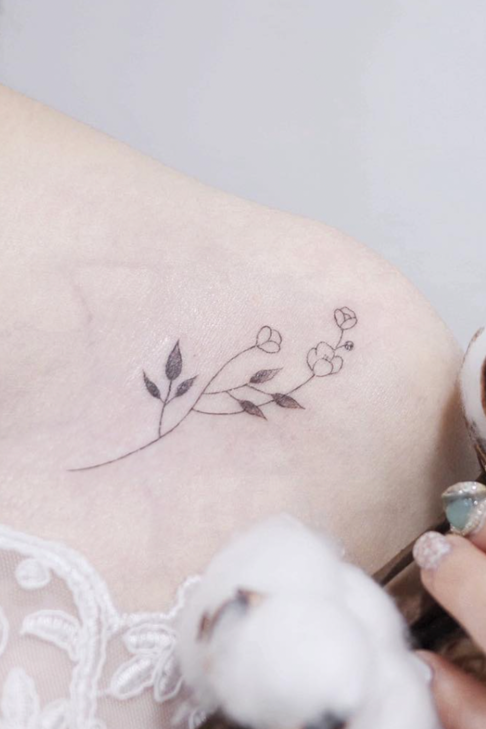 small black and white flower tattoo on shoulder