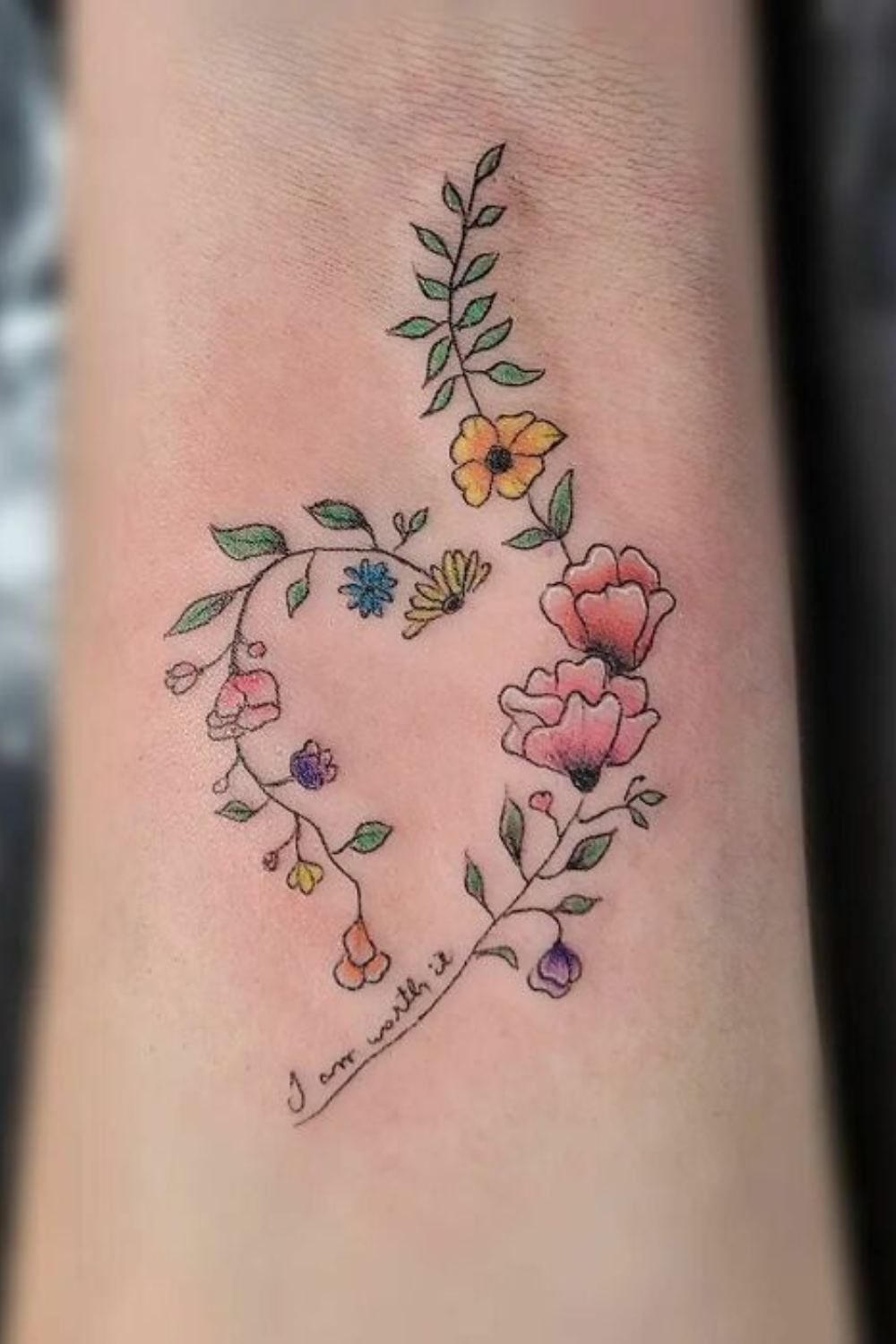 small-flower tattoo on forearm with message i am worth it