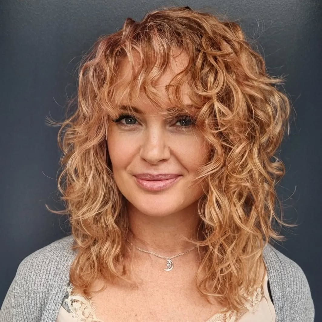 medium-length-curly-shaggy-cut-with-rosegold-color-for-older-women