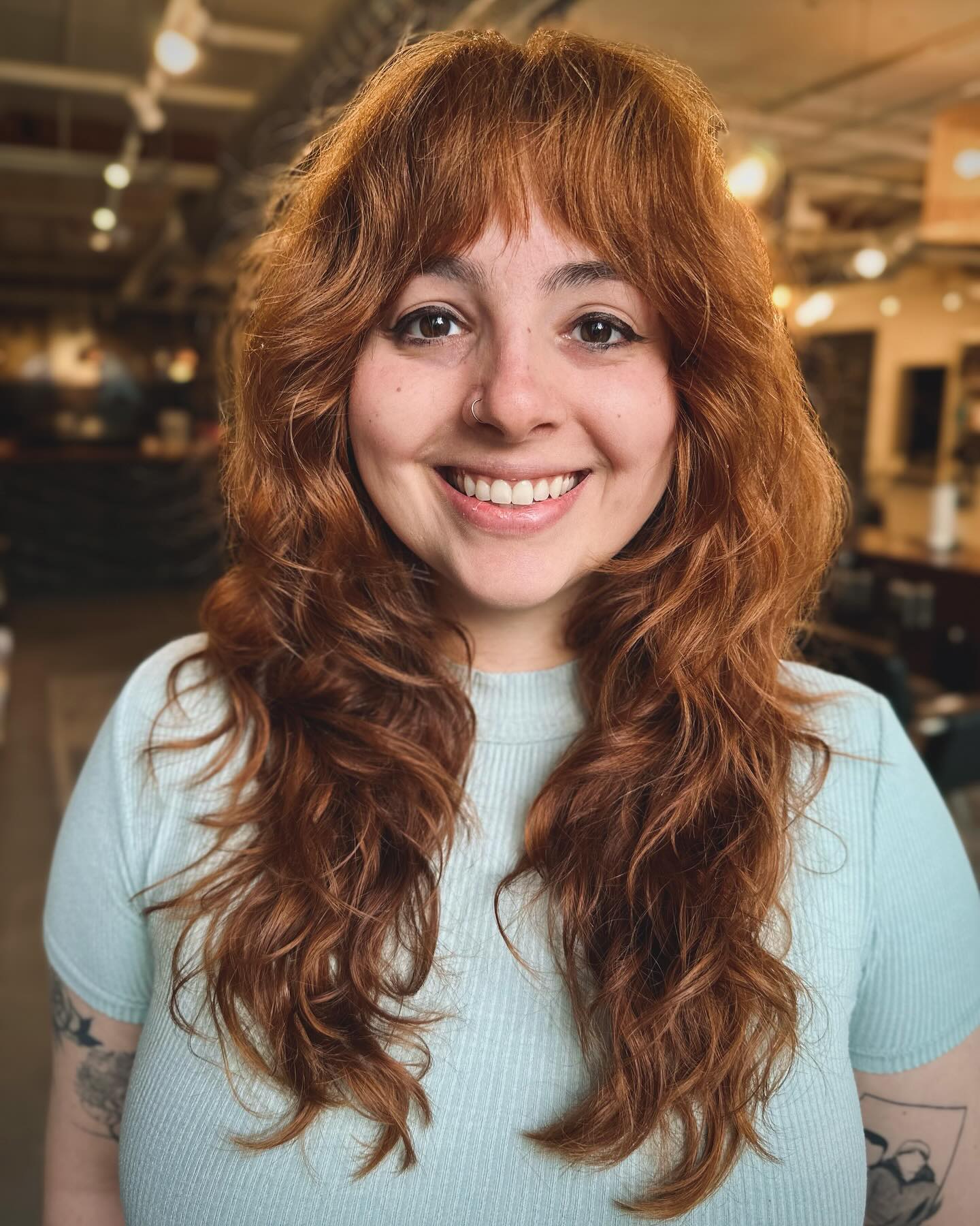 shaggy-cut-with-bangs-on-auburn-colored-hair