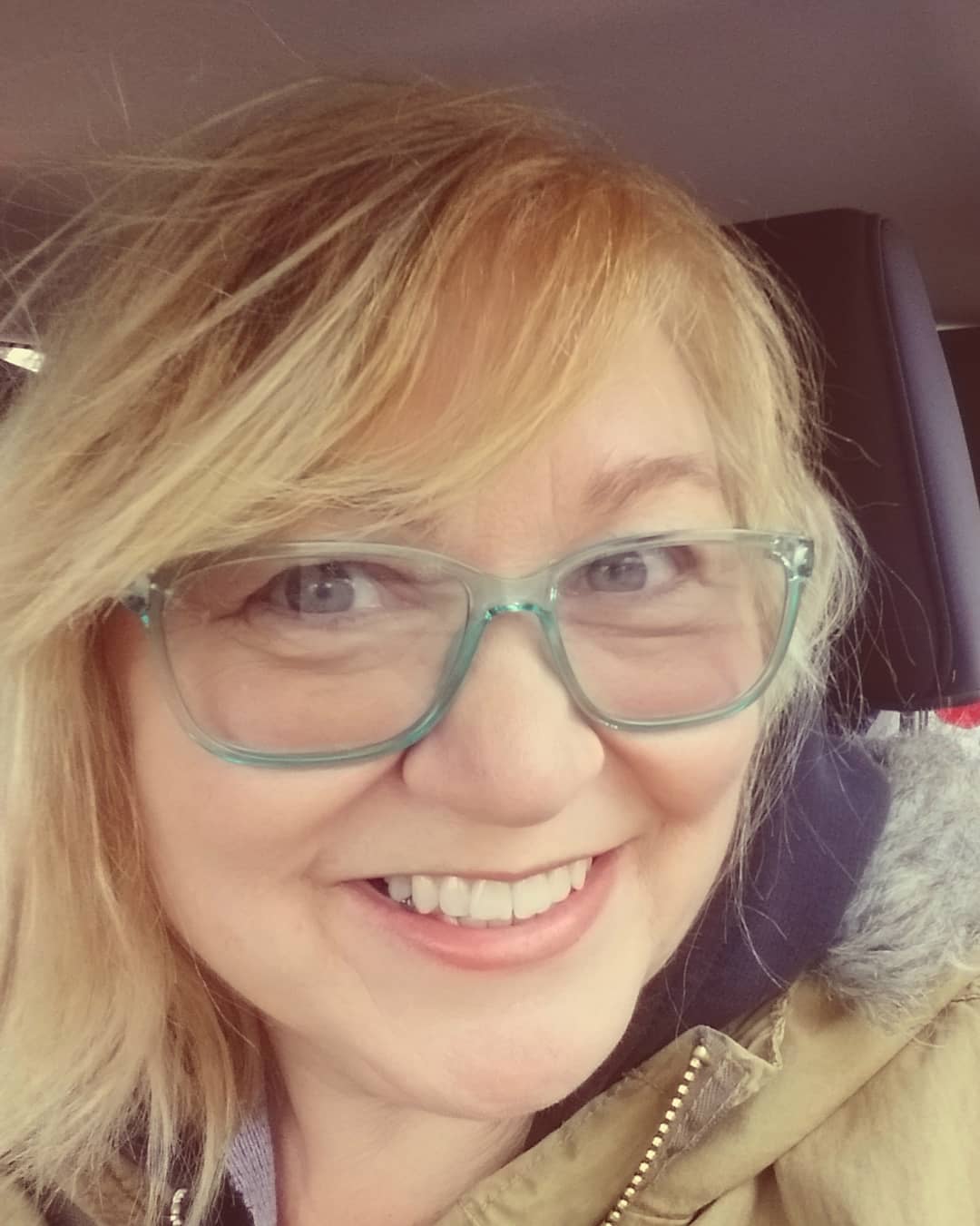 side-parted-blonde-hair-with-light-blue-glasses