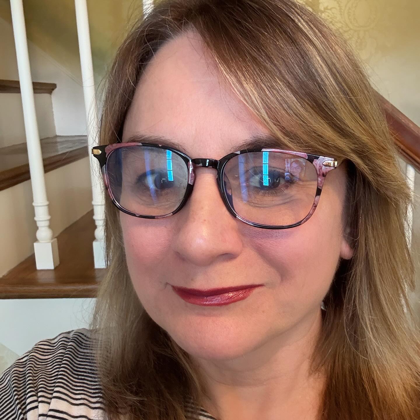 pink-and-grey-patterned-glasses-on-brown-hair