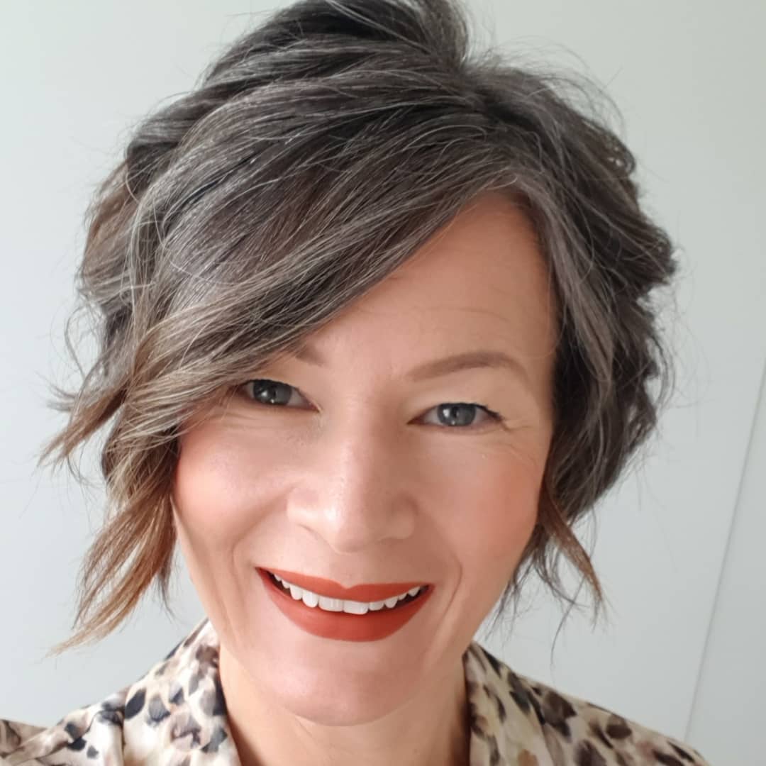 Layered bixie with side swept curled layers