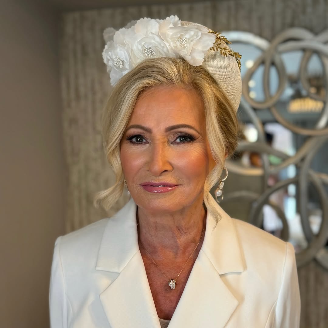 Updo wuth Loose Front Layers Paired with a White Flower Moonband