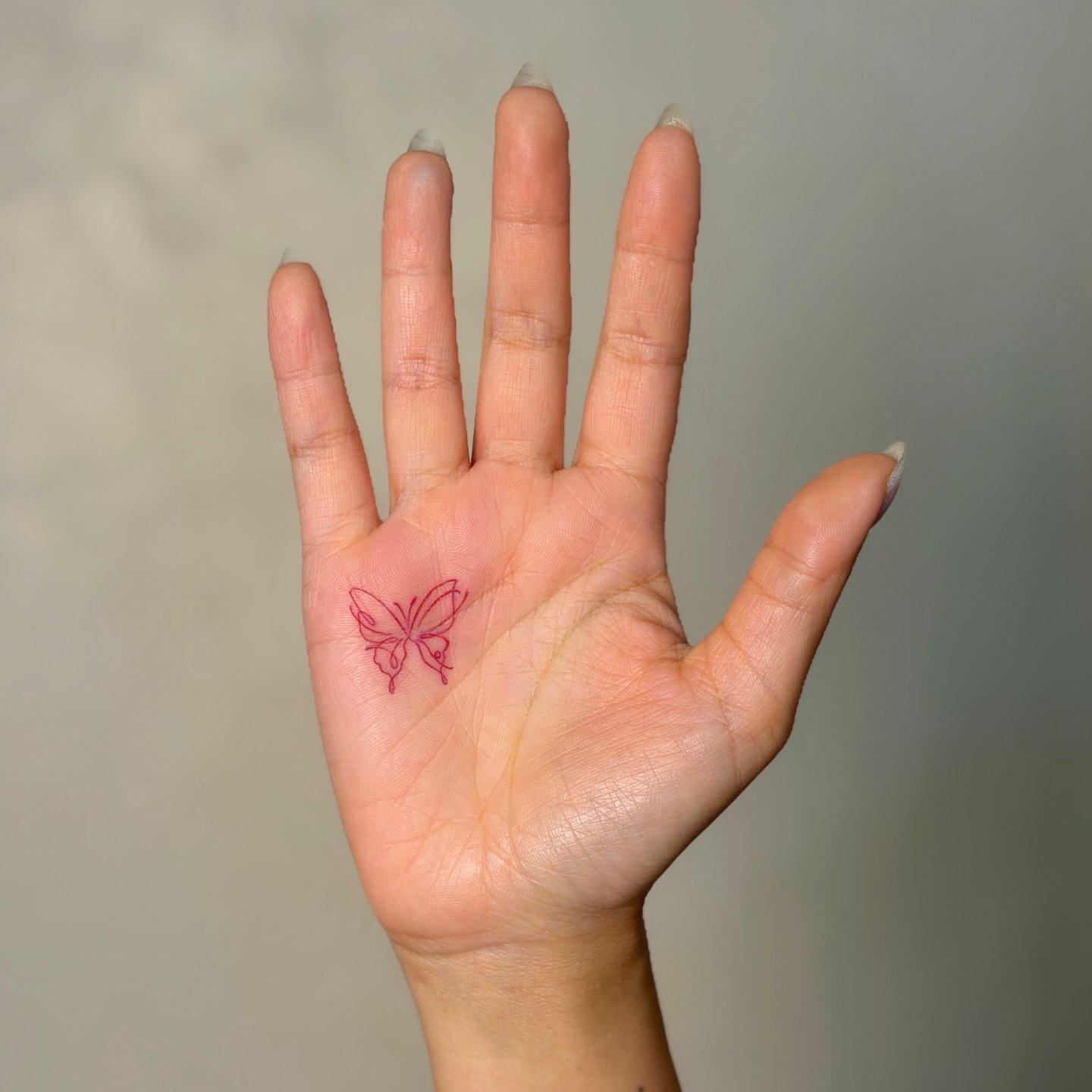 red-abstract-butterfly-tattoo-on-palm